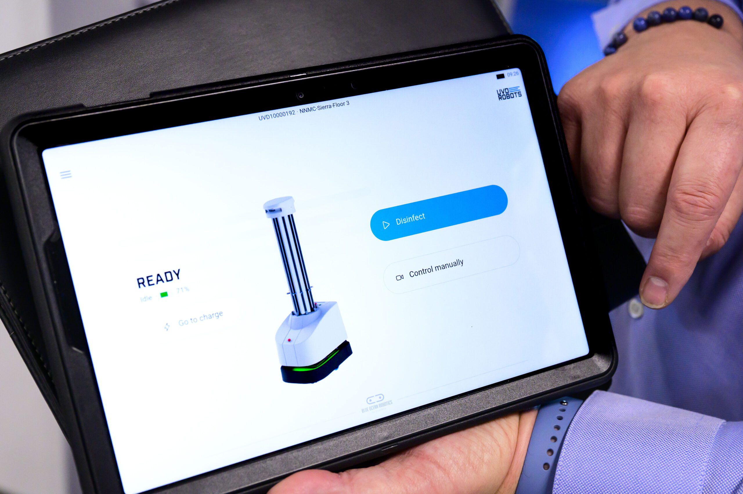 iPad with robot control panel visible