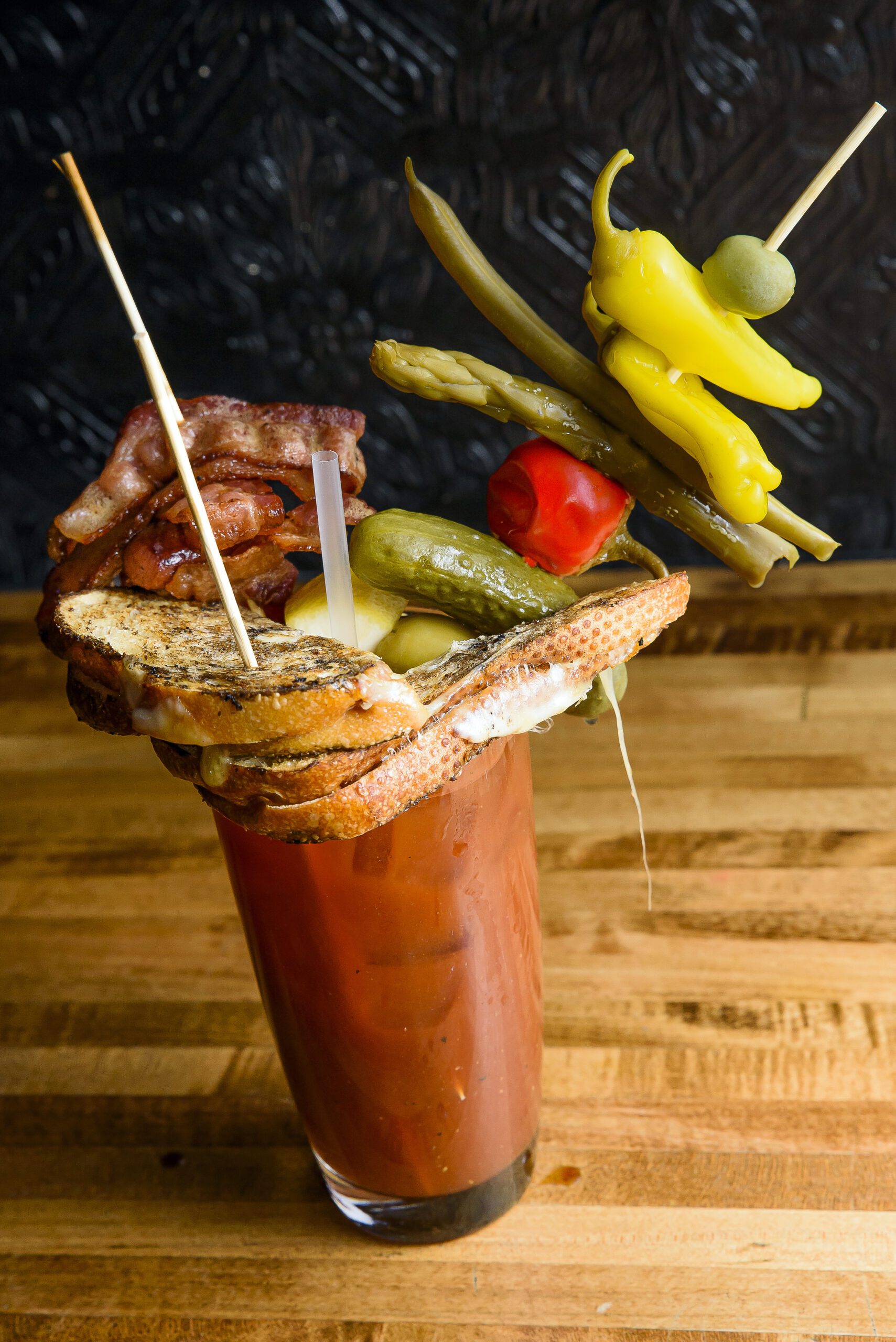 Bloody Mary filled with grilled cheese, bacon, peppers, pickles, green beans