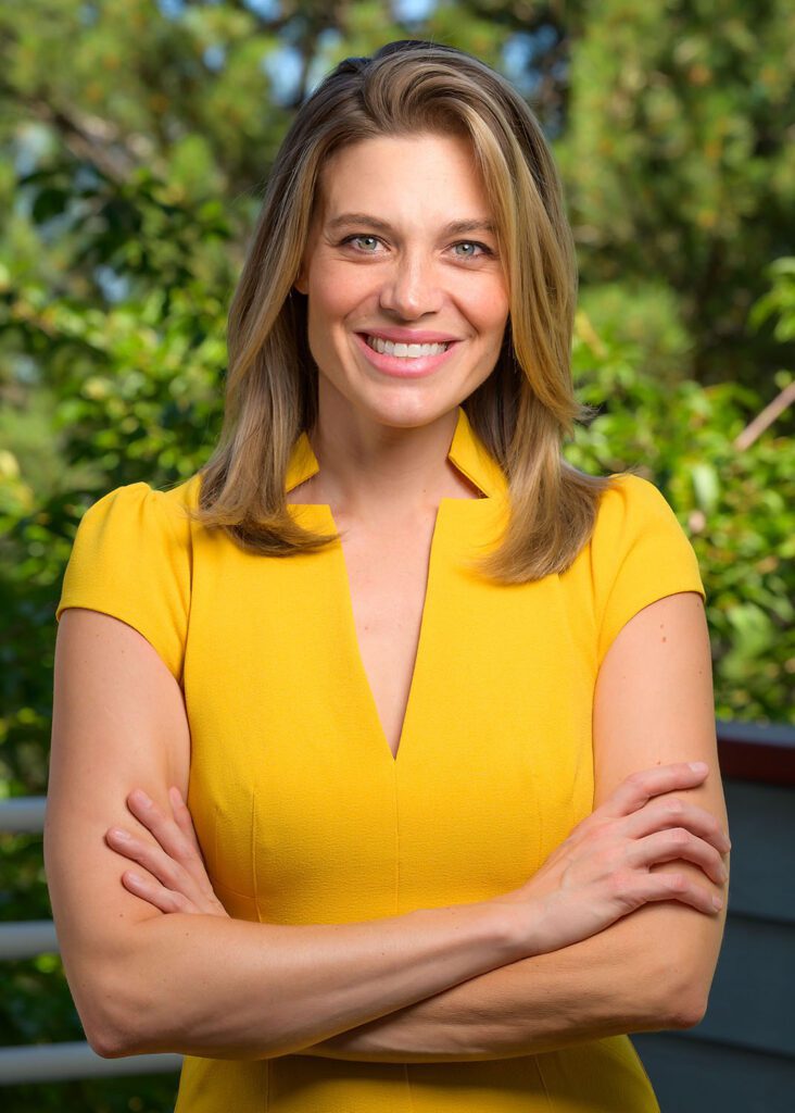 Woman facing camera with arms folded