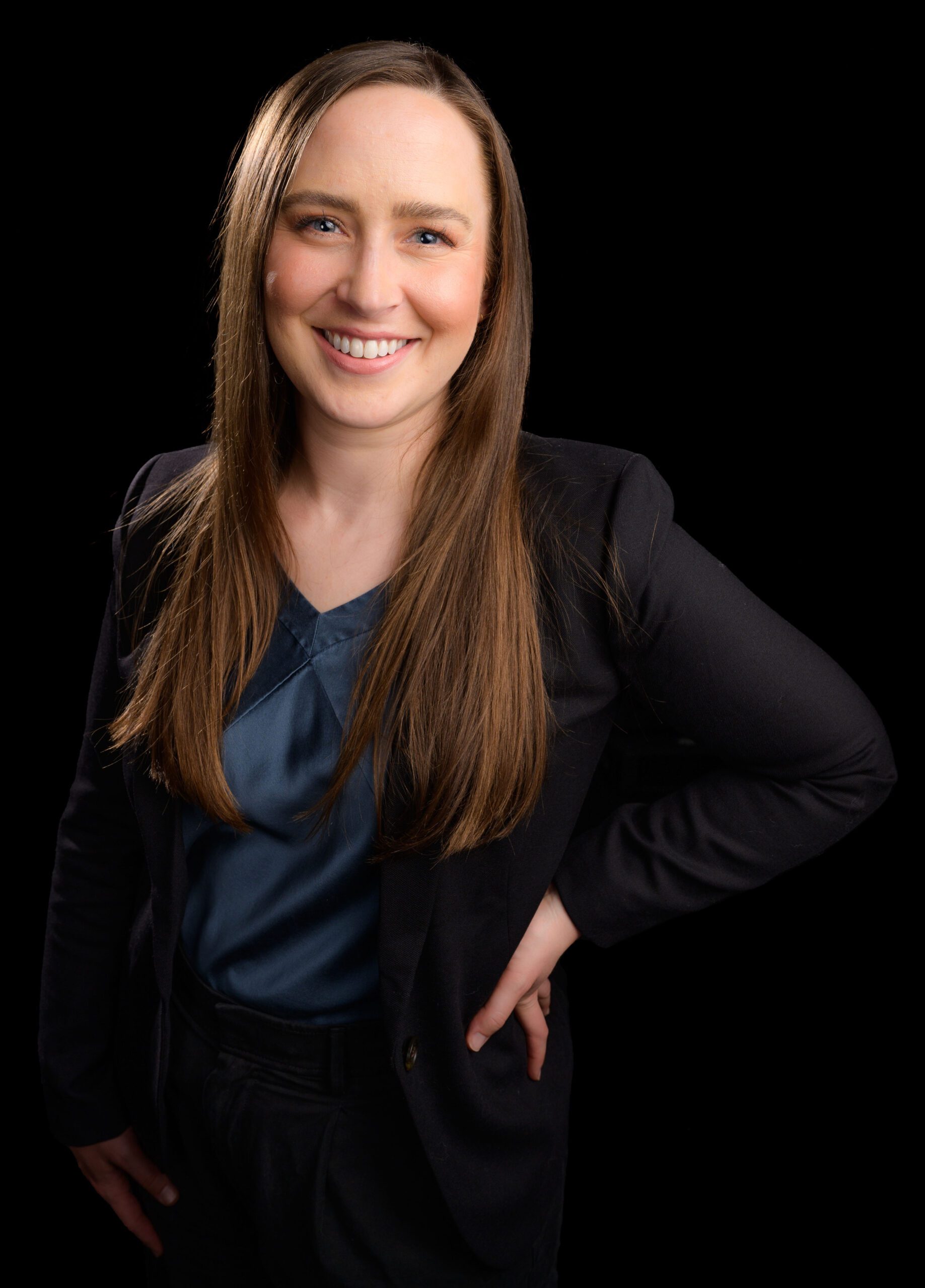 Woman poses for camera with hands on hip