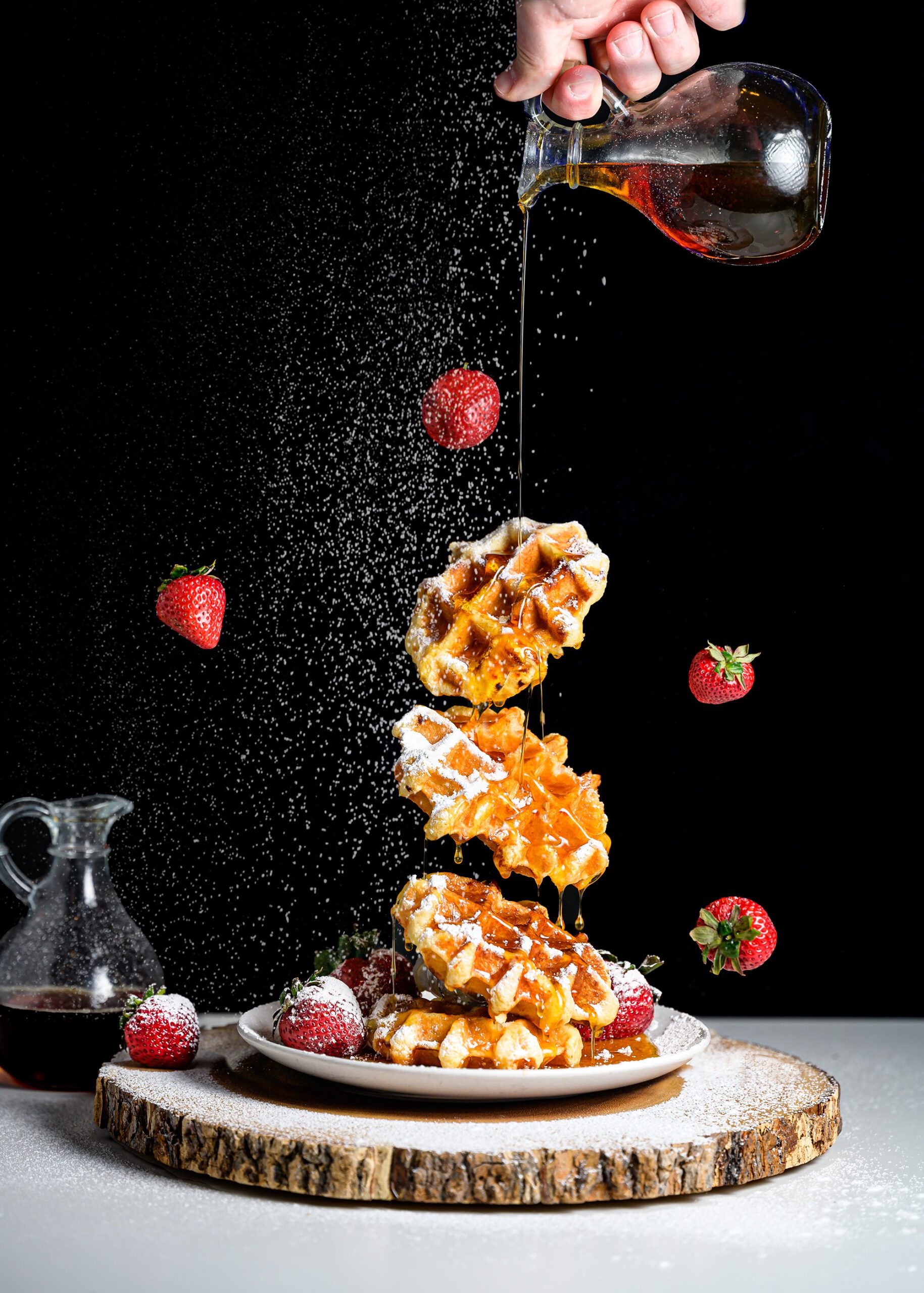 Floating waffles with exploding sugar and strawberries