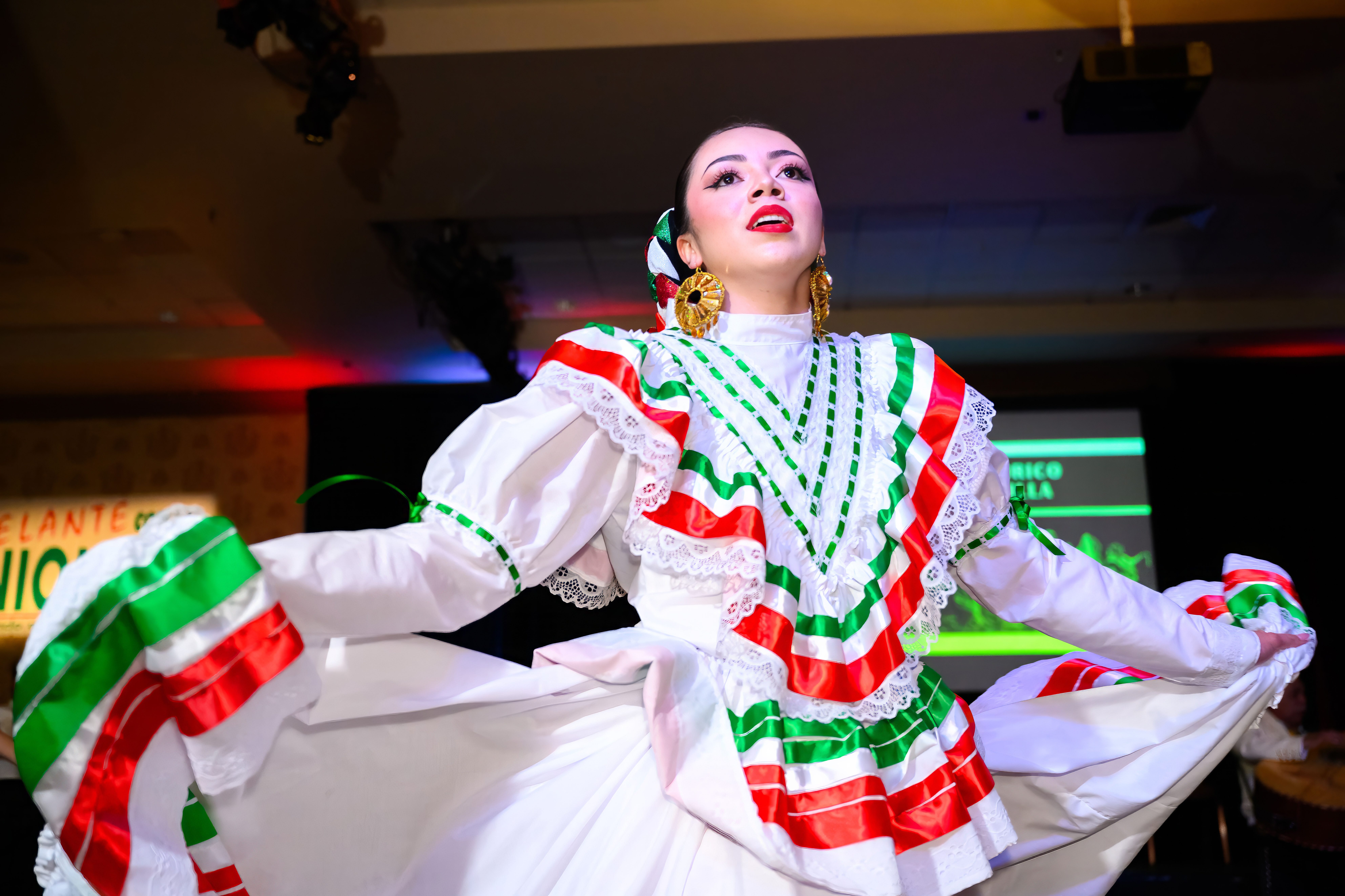 Woman in traditional Mexican dress dancing