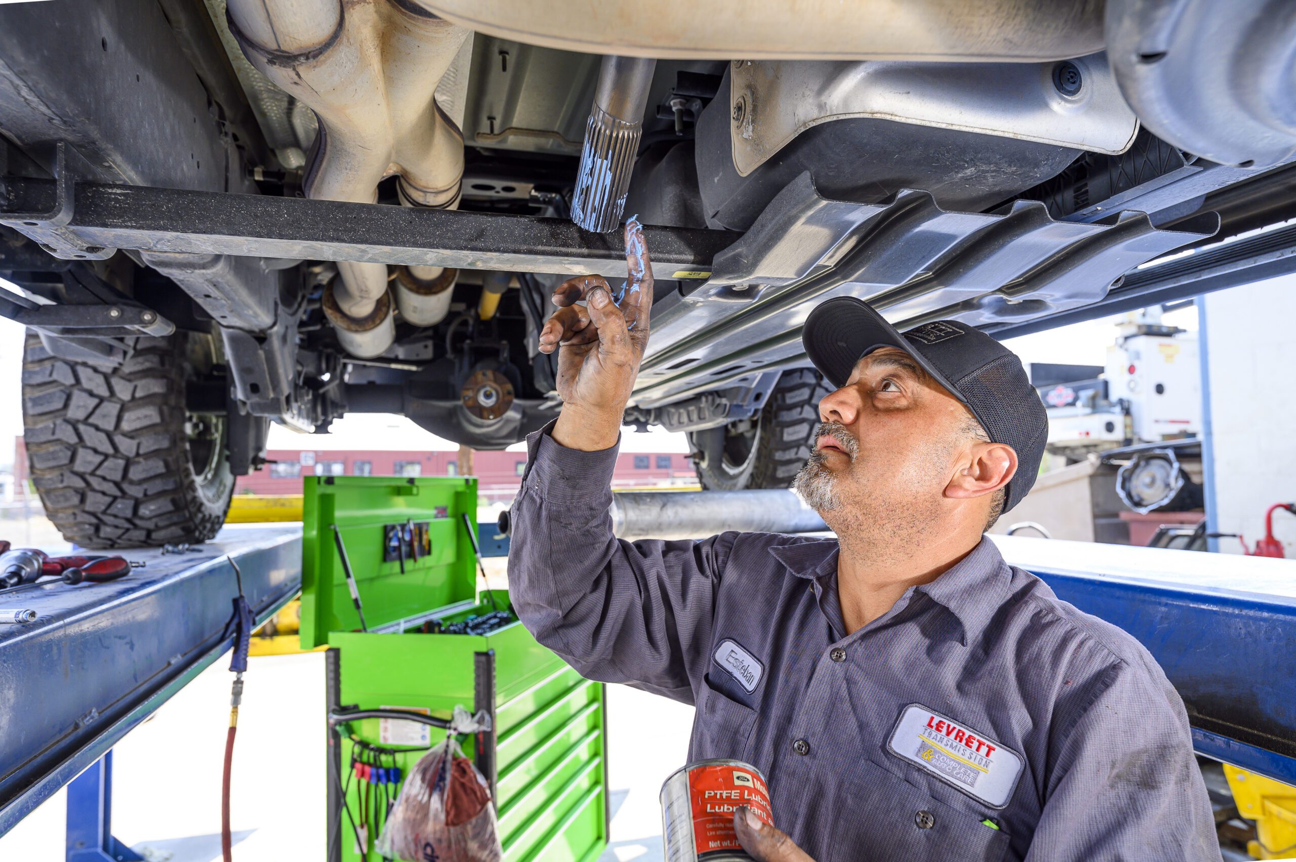 Man facing the camera points out at the crowd while holding a raffle ticket